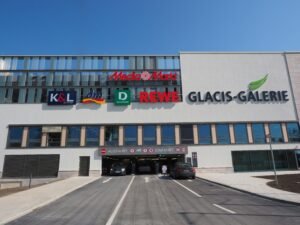 View of Glacis-Galerie shopping center entrance with parking access.