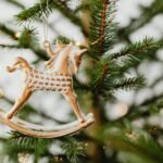 Close-up of a horse ornament on a decorated Christmas tree.