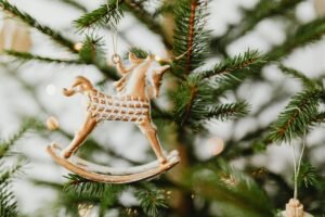 Close-up of a horse ornament on a decorated Christmas tree.